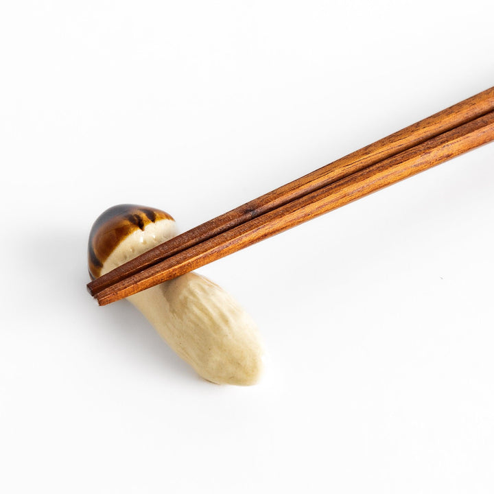 Matsutake Mushroom Chopstick Rest, a realistic ceramic rest shaped like a matsutake mushroom, perfect for holding chopsticks with a natural, earthy touch.