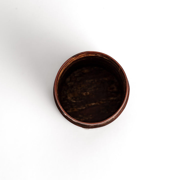 Traditional Japanese tea canister crafted from cherry bark with a delicate cherry blossom design, perfect for storing and preserving tea leaves.