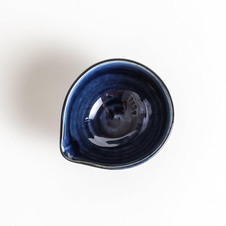 A small condiment bowl in deep, glossy blue.