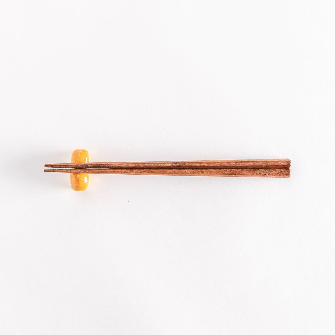 The milk bread chopsticks rest with chopsticks placed across it, photographed to show the full setup.
