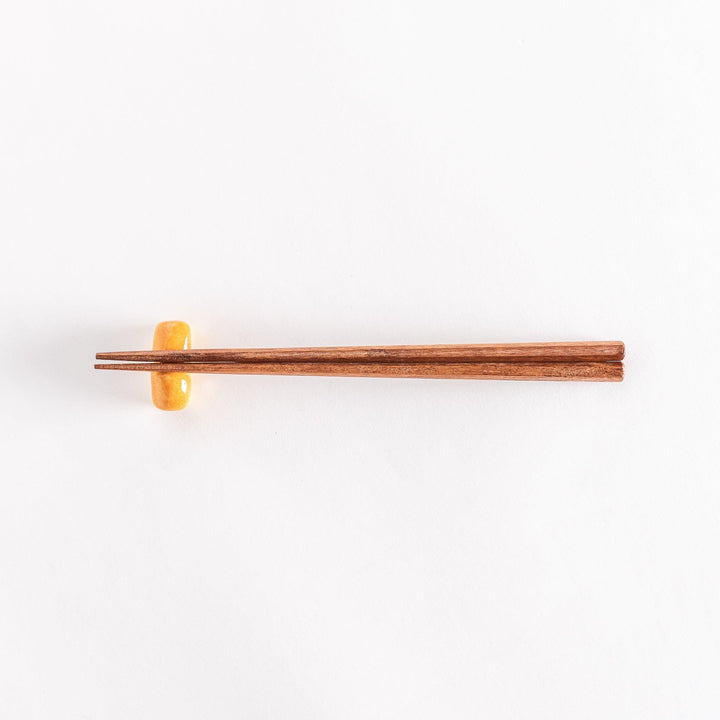 The milk bread chopsticks rest with chopsticks placed across it, photographed to show the full setup.
