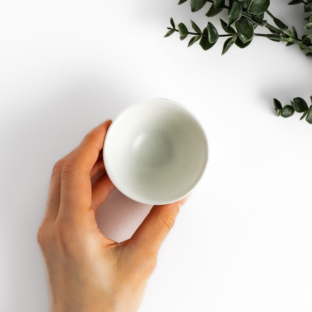 Minimalist ribbed white teacup with a gently flared rim and a smooth base, offering a simple yet elegant design perfect for everyday tea rituals.