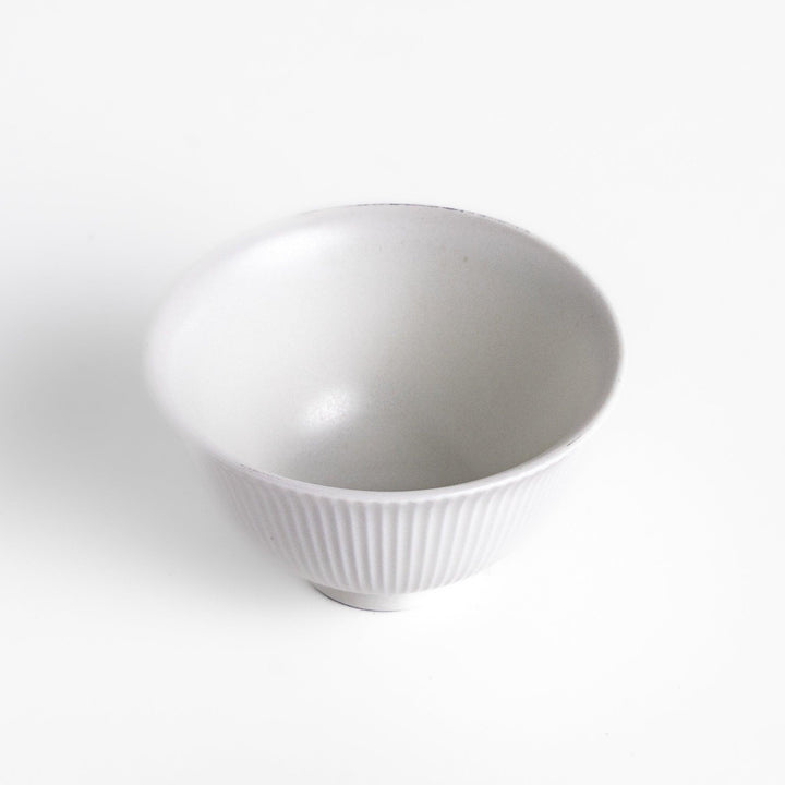 Minimalist ribbed white teacup with a gently flared rim and a smooth base, offering a simple yet elegant design perfect for everyday tea rituals.