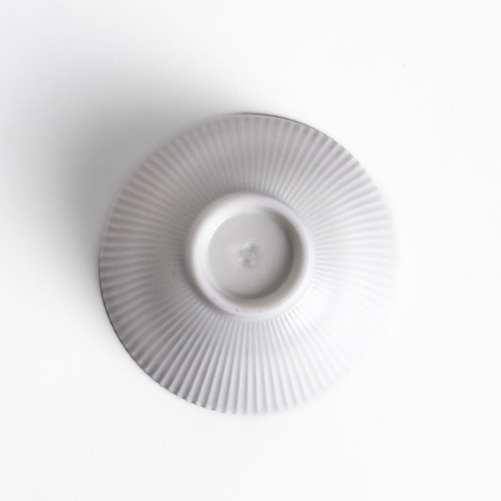 Minimalist ribbed white teacup with a gently flared rim and a smooth base, offering a simple yet elegant design perfect for everyday tea rituals.