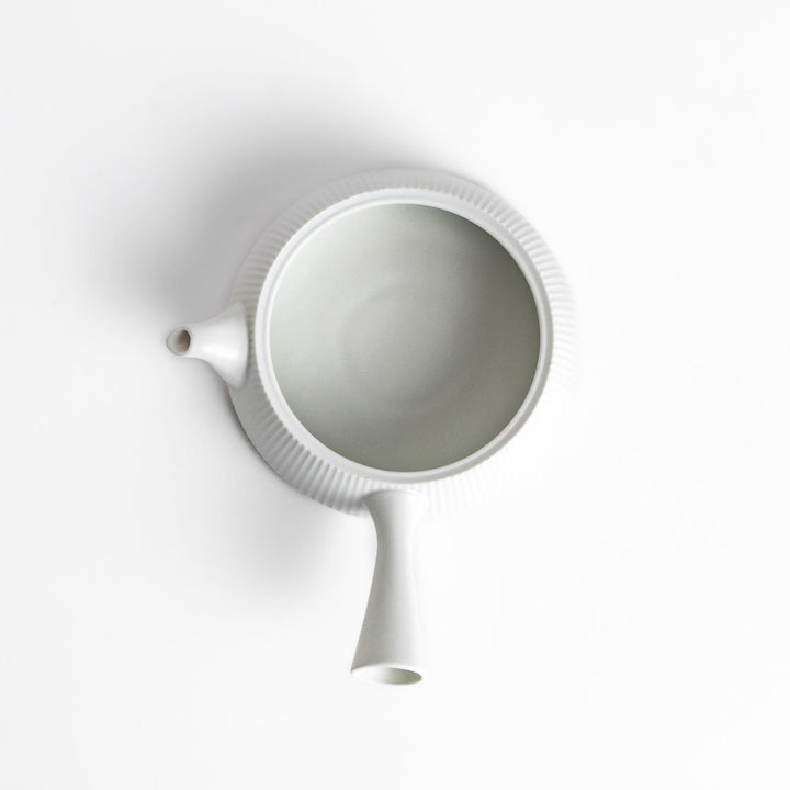 Minimalist ribbed white teapot with a sleek spout and a simple, elegant design, featuring a round lid with a textured top for a modern touch to your tea set.