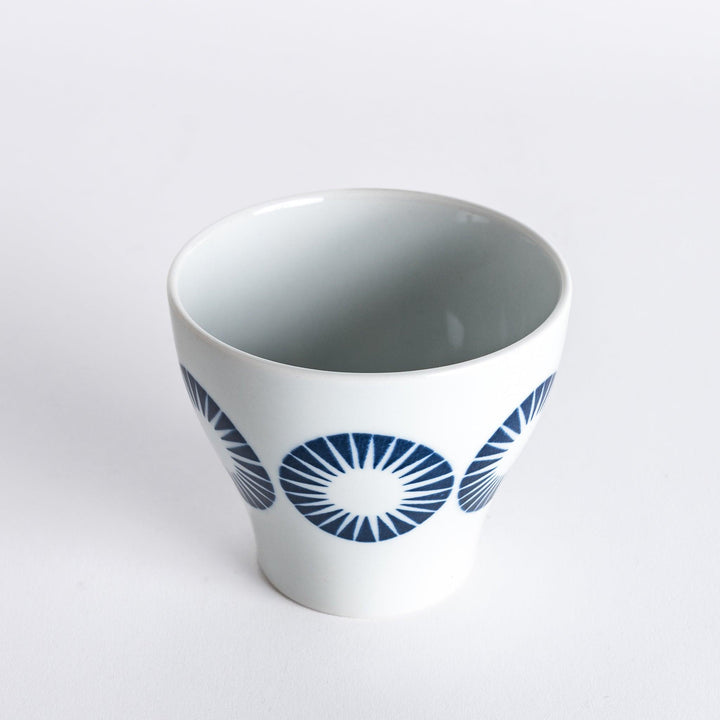 Slightly angled view of the Modern Indigo Circle Cup, highlighting the navy blue radiating circle pattern on the white body.