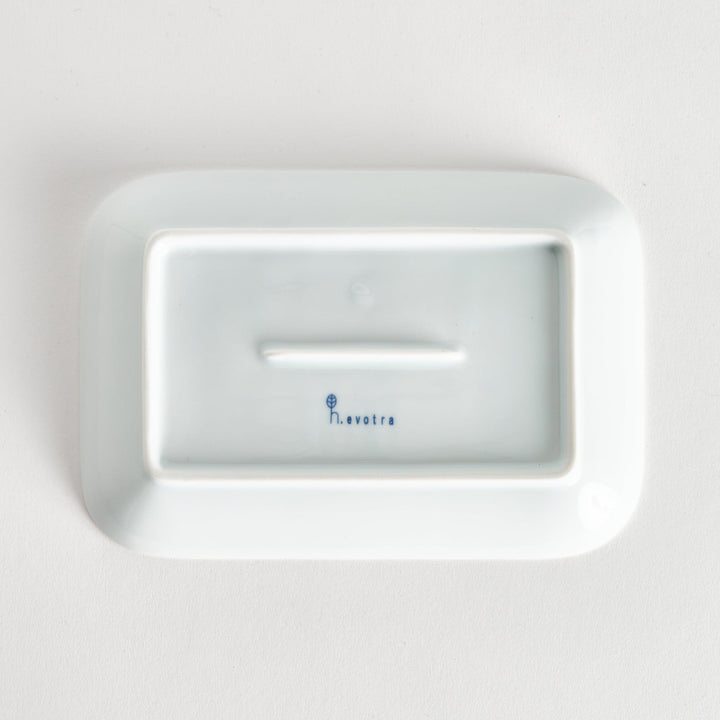 Five pieces featuring the Modern Indigo Circle design, including two cups, two rectangular plates, and a small dish, all adorned with navy blue radiating circle patterns.