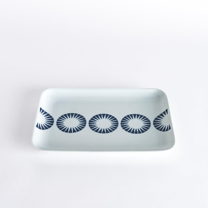 Slightly angled view of the Modern Indigo Circle Dinner Plate, showcasing the navy blue concentric circle pattern across the white surface.