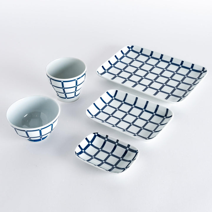 Five pieces featuring the Modern Indigo Lattice design, including two cups, two rectangular plates, and a small dish.
