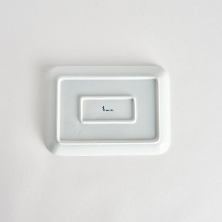 Bottom view of the Modern Indigo Lattice Dinner Plate, displaying the smooth white surface with the maker's mark visible.