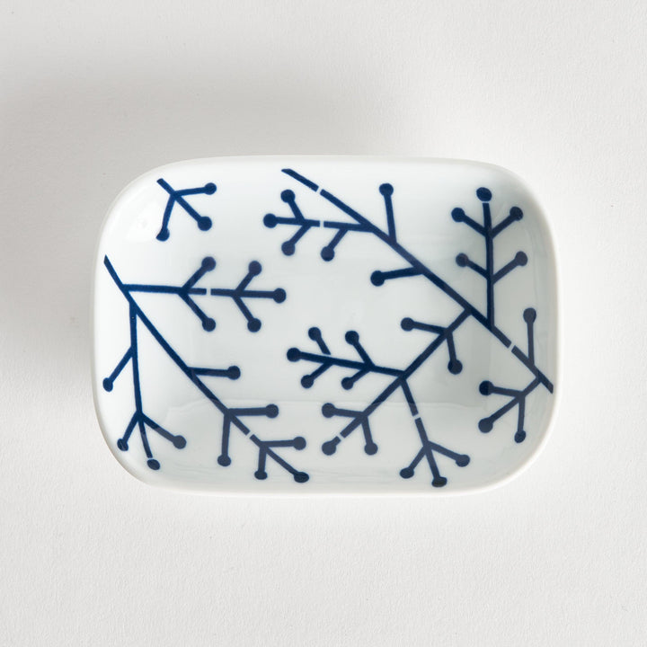Rectangular white porcelain sauce dish featuring a bold indigo pine branch design. The clean lines highlight its modern style.