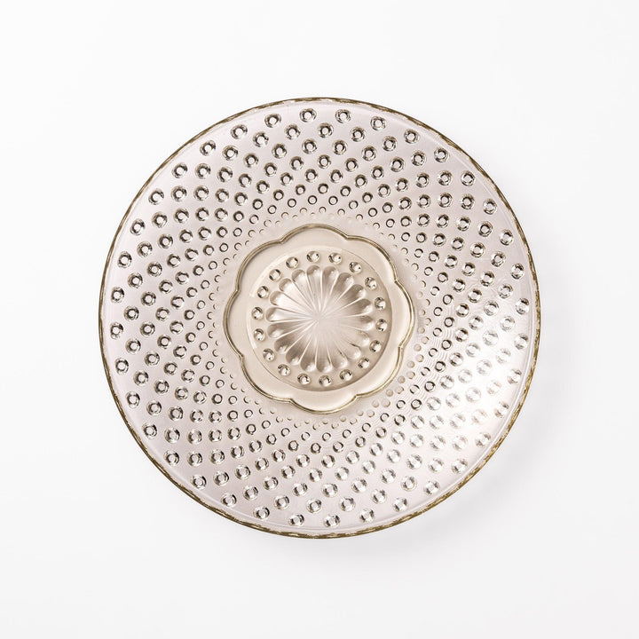 Amber-toned glass dessert bowl and saucer set with raised dot pattern and starburst base, ideal for refined sweets or fruit servings.