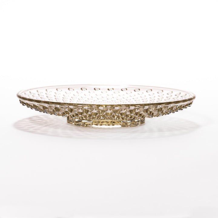 Amber-toned glass dessert bowl and saucer set with raised dot pattern and starburst base, ideal for refined sweets or fruit servings.