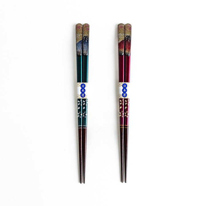A boxed set of two pairs of chopsticks, one with blue and one with red handles, featuring Mount Fuji designs.