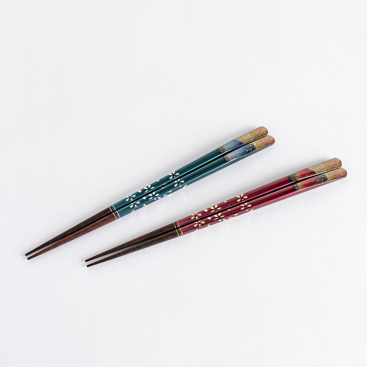 A boxed set of two pairs of chopsticks, one with blue and one with red handles, featuring Mount Fuji designs.