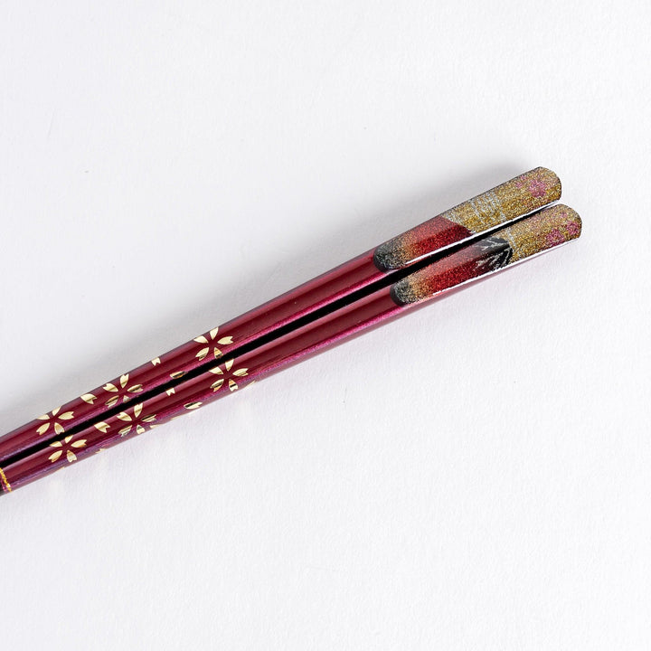 A boxed set of two pairs of chopsticks, one with blue and one with red handles, featuring Mount Fuji designs.