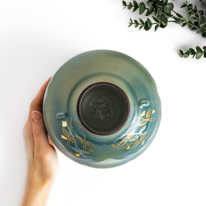 Handcrafted vase featuring a tranquil mountain scene with golden leaf accents and delicate trees, capturing a serene, nature-inspired design in soft teal tones.