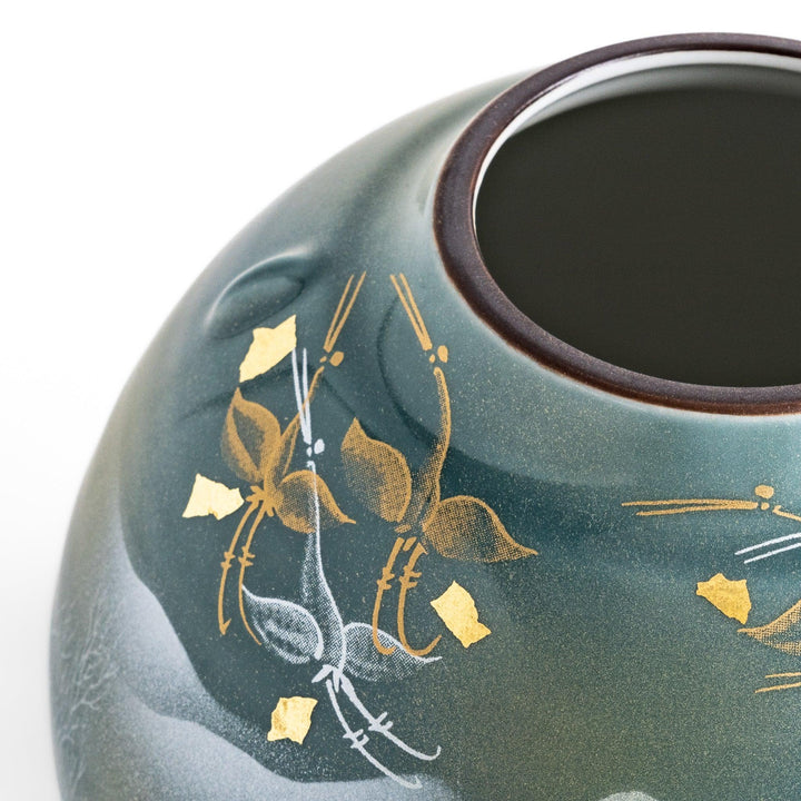 Handcrafted vase featuring a tranquil mountain scene with golden leaf accents and delicate trees, capturing a serene, nature-inspired design in soft teal tones.