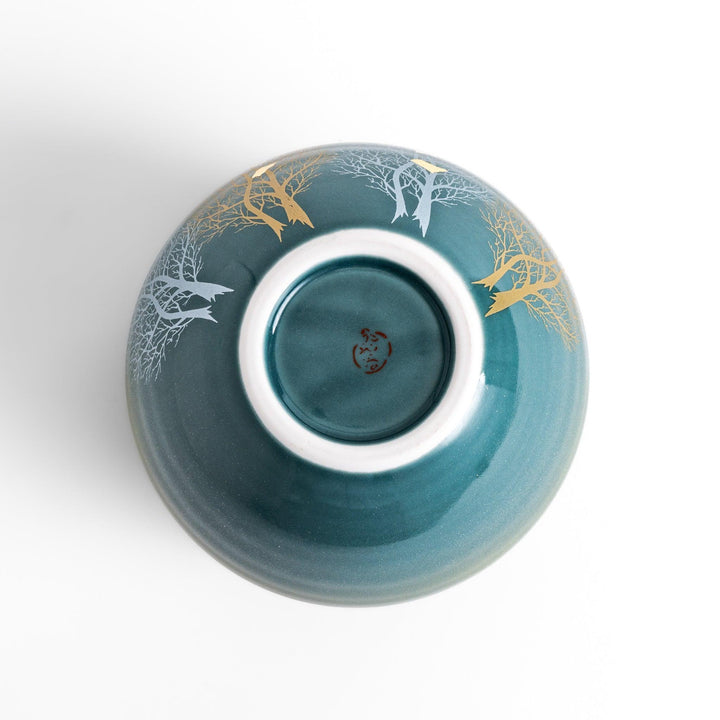 Handcrafted vase featuring a tranquil mountain scene with golden leaf accents and delicate trees, capturing a serene, nature-inspired design in soft teal tones.
