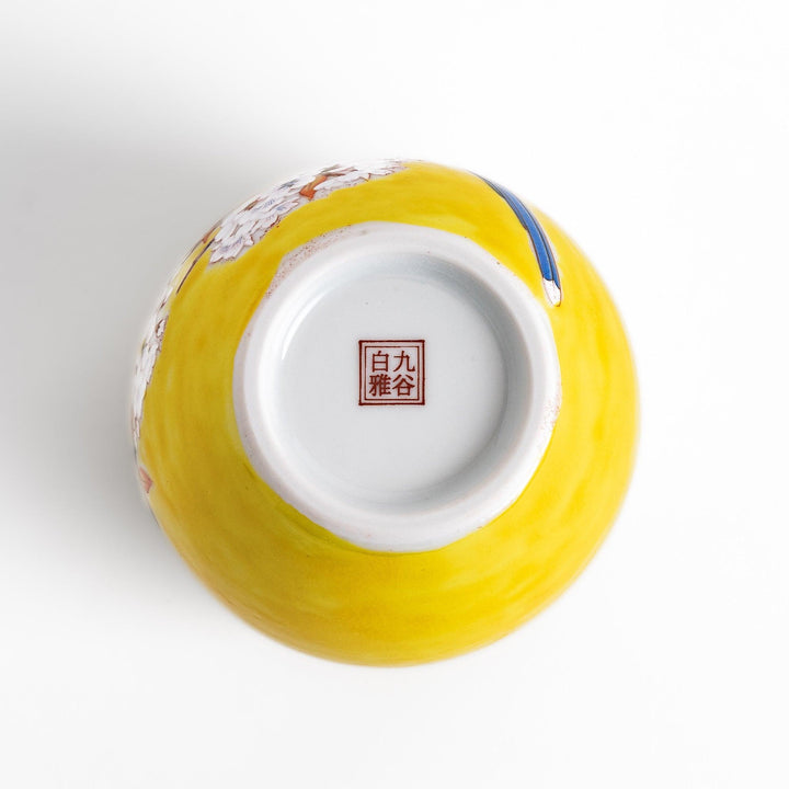 Bright yellow vase adorned with delicate cherry blossoms and a colorful bird, capturing the essence of spring in a beautifully painted design.
