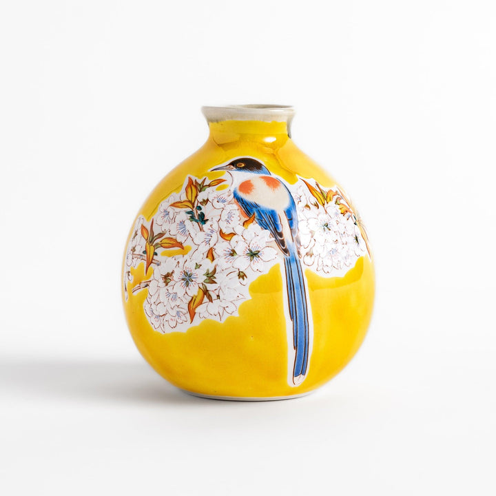 Yellow sake bottle featuring a vibrant cherry blossom and bird design, perfect for adding a touch of spring beauty to your tableware collection.