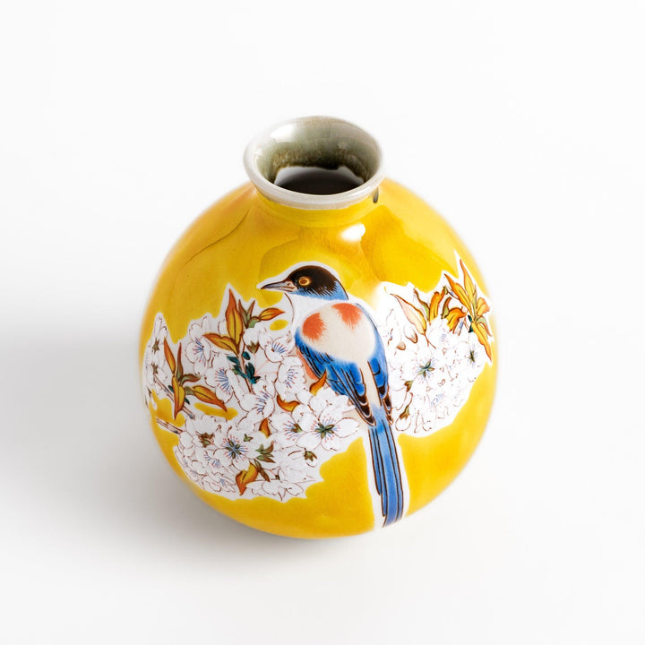 Yellow sake bottle featuring a vibrant cherry blossom and bird design, perfect for adding a touch of spring beauty to your tableware collection.
