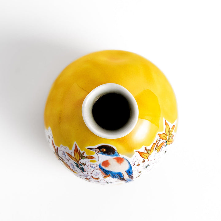 Yellow sake bottle featuring a vibrant cherry blossom and bird design, perfect for adding a touch of spring beauty to your tableware collection.