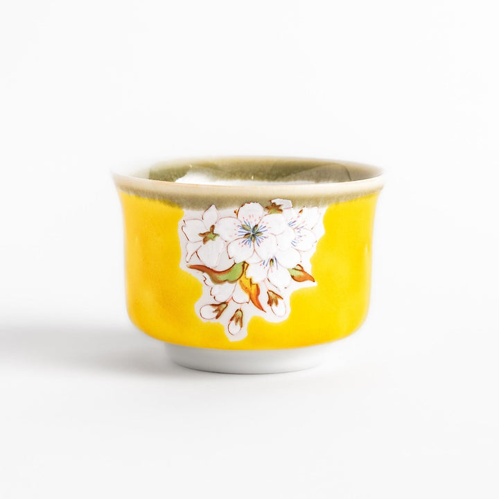 Yellow sake cup with a delicate cherry blossom design, perfectly complementing spring-themed tableware for a vibrant and charming dining experience.