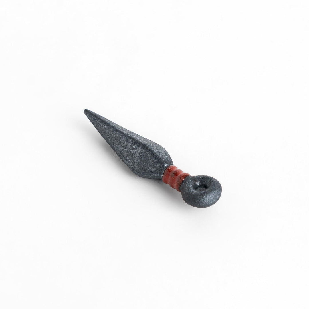 Sleek ninja blade-shaped chopstick rest with a metallic finish and red accent, adding a bold and unique touch to your dining experience.