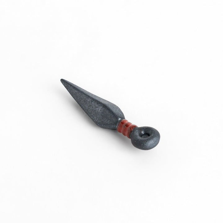 Sleek ninja blade-shaped chopstick rest with a metallic finish and red accent, adding a bold and unique touch to your dining experience.