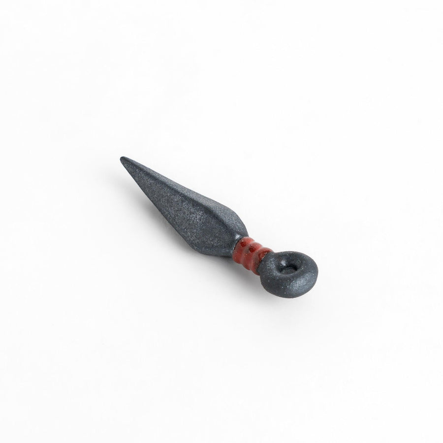 Sleek ninja blade-shaped chopstick rest with a metallic finish and red accent, adding a bold and unique touch to your dining experience.