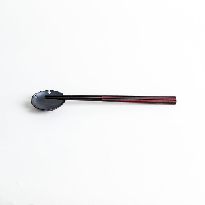Octagonal wooden chopsticks with a brown tone, finished with a textured grain. Available in red or black.