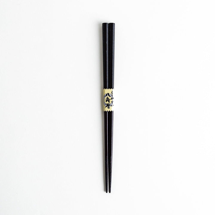 Octagonal wooden chopsticks with a brown tone, finished with a textured grain. Available in red or black.