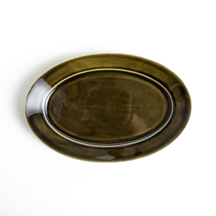 Sleek, dark brown or olive colored oval dinner plate with a glossy finish, simple and minimalist.