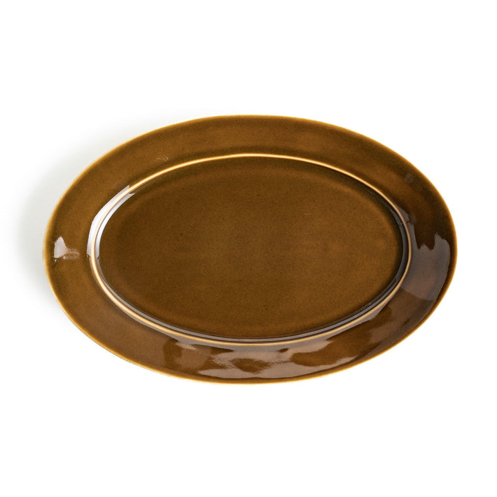 Sleek, dark brown or olive colored oval dinner plate with a glossy finish, simple and minimalist.