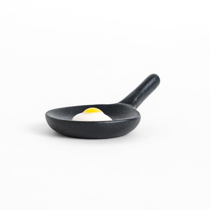 Chopstick rest shaped like a frying pan with a realistic fried egg design, adding a fun and playful touch to your dining experience.