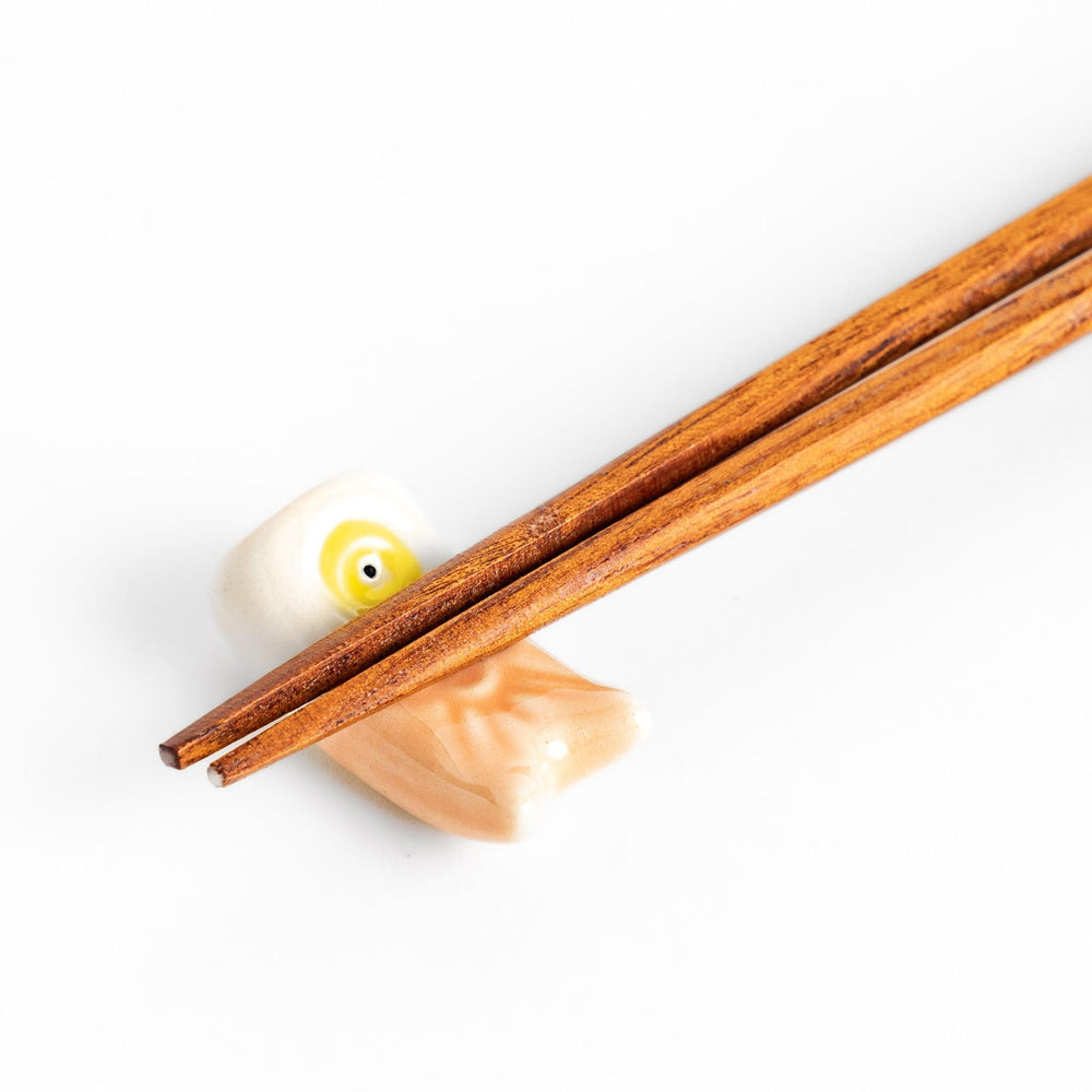 Peach carp streamer chopstick rest with a playful yellow eye design.