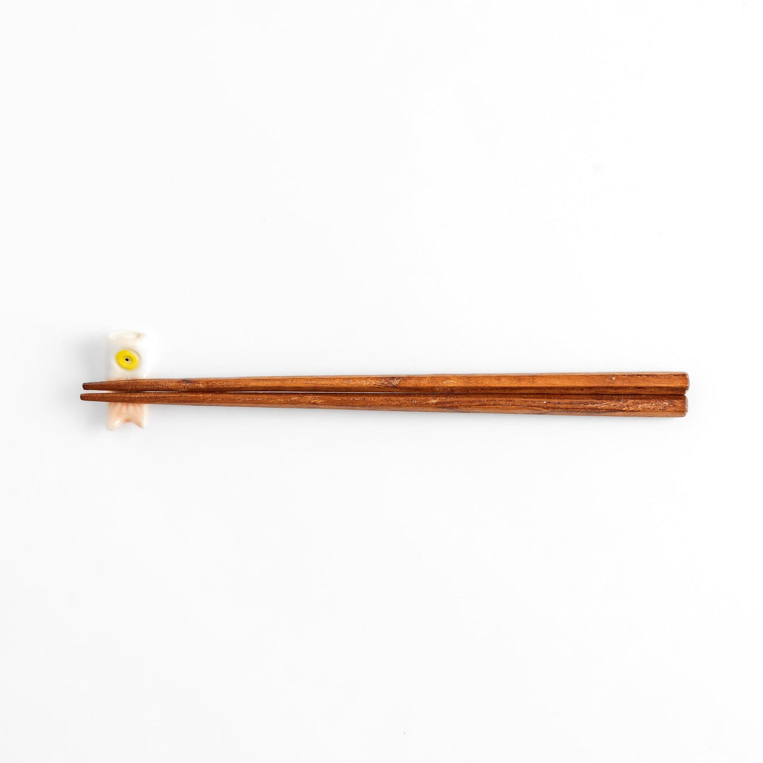 Peach carp streamer chopstick rest with a playful yellow eye design.