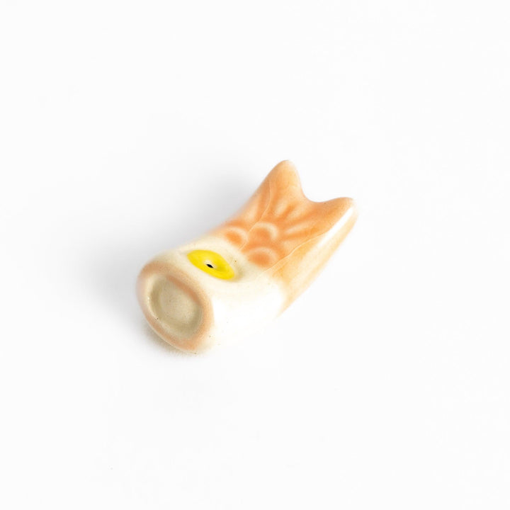Peach carp streamer chopstick rest with a playful yellow eye design.