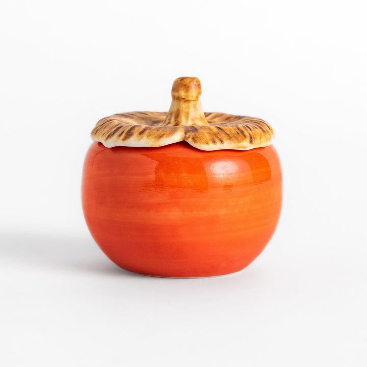 Persimmon Lidded Condiment Bowl, a ceramic bowl with a glossy orange finish and a detailed lid shaped like a persimmon leaf, perfect for serving sauces and condiments.