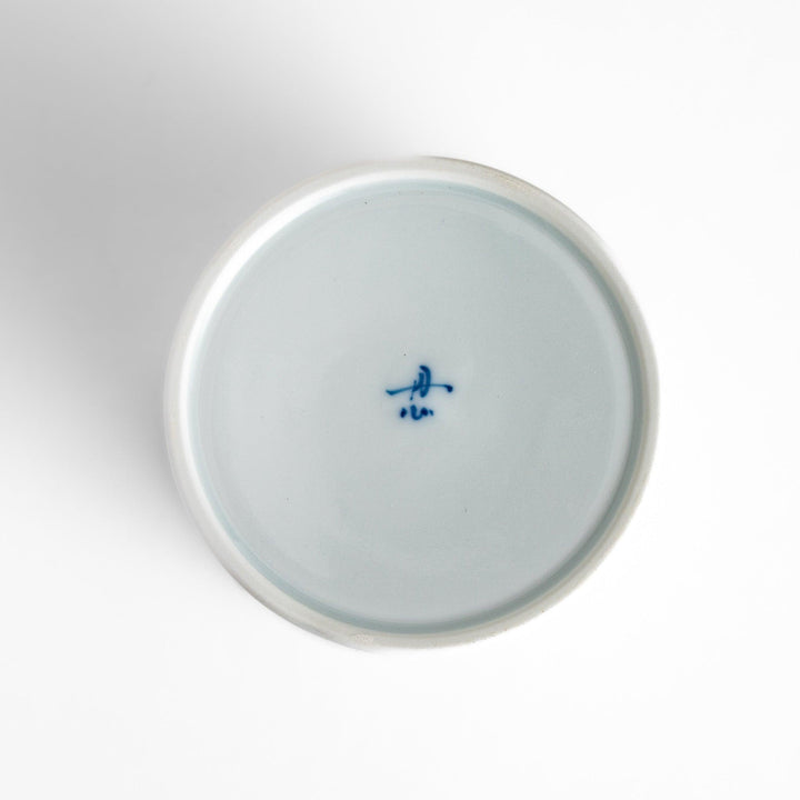 Unique ceramic glass featuring a delicate cut-out floral design, perfect for adding a touch of elegance to any table.