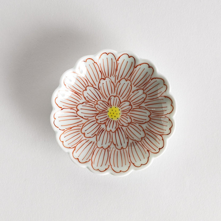 A small round dessert bowl with a delicate blue chrysanthemum pattern and scalloped edges.