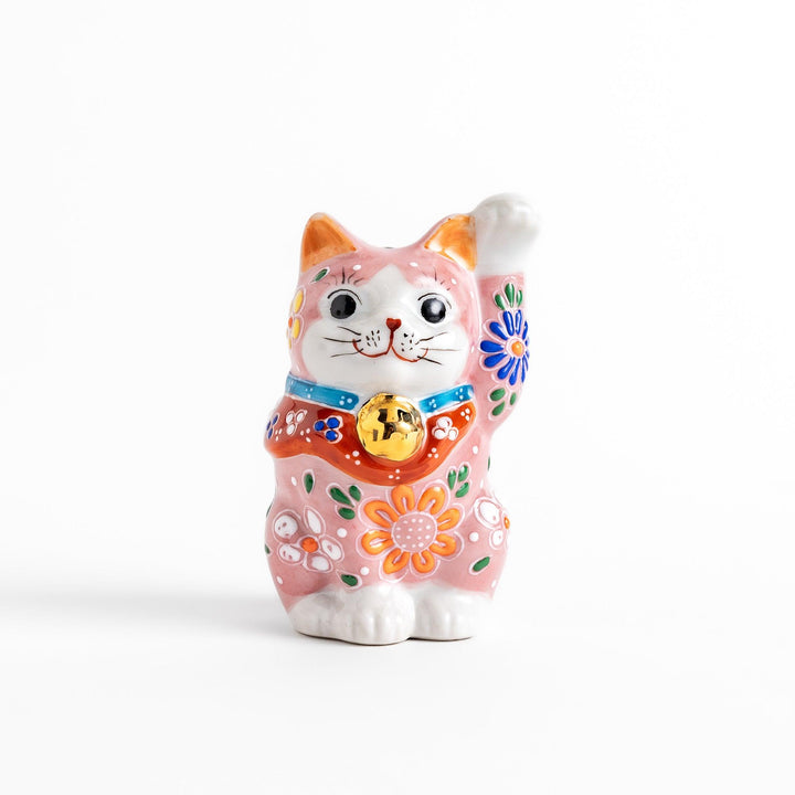 Charming pink blossom Maneki Neko figurine, adorned with colorful floral patterns and a golden bell, symbolizing good luck and prosperity with a cheerful waving gesture.