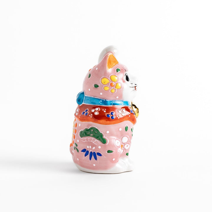 Charming pink blossom Maneki Neko figurine, adorned with colorful floral patterns and a golden bell, symbolizing good luck and prosperity with a cheerful waving gesture.