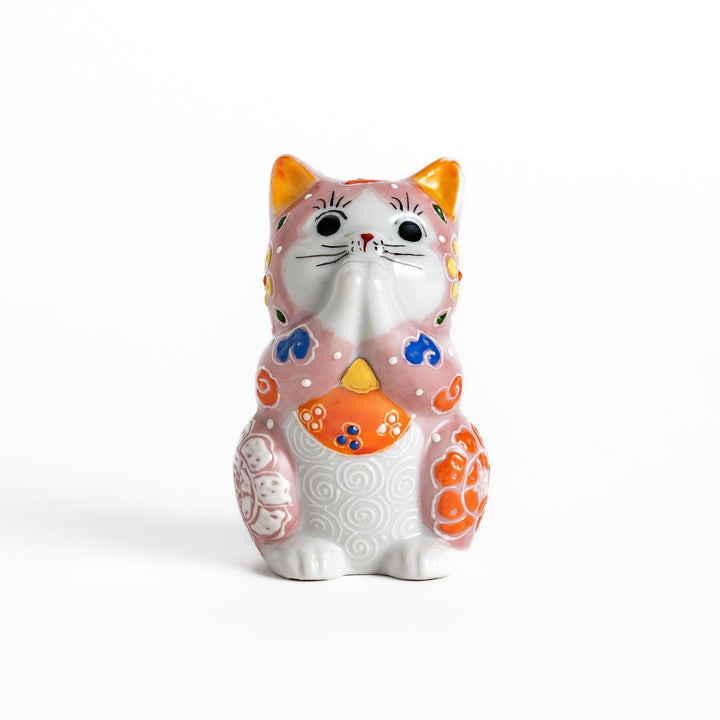 Maneki Neko figurine featuring a pink blossom design with vibrant colors and a praying posture for good fortune.