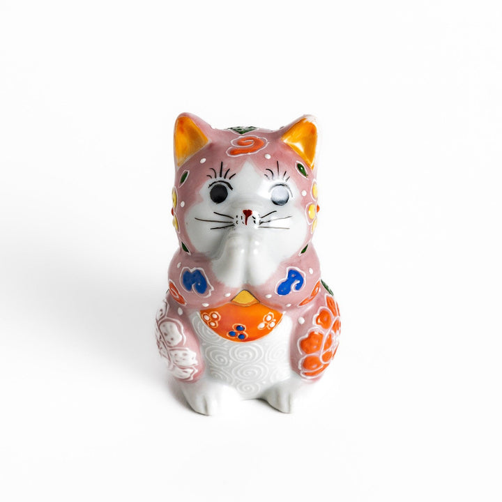 Maneki Neko figurine featuring a pink blossom design with vibrant colors and a praying posture for good fortune.