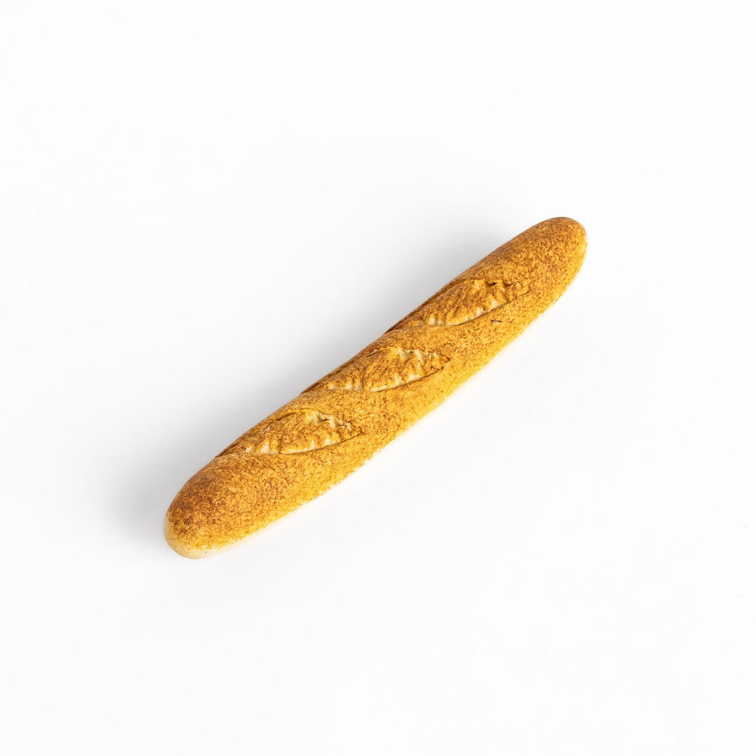 Plain baguette-shaped chopstick rest with a simple, elegant design, featuring detailed imprints resembling the crust of a baguette.