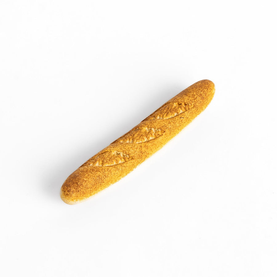 Plain baguette-shaped chopstick rest with a simple, elegant design, featuring detailed imprints resembling the crust of a baguette.