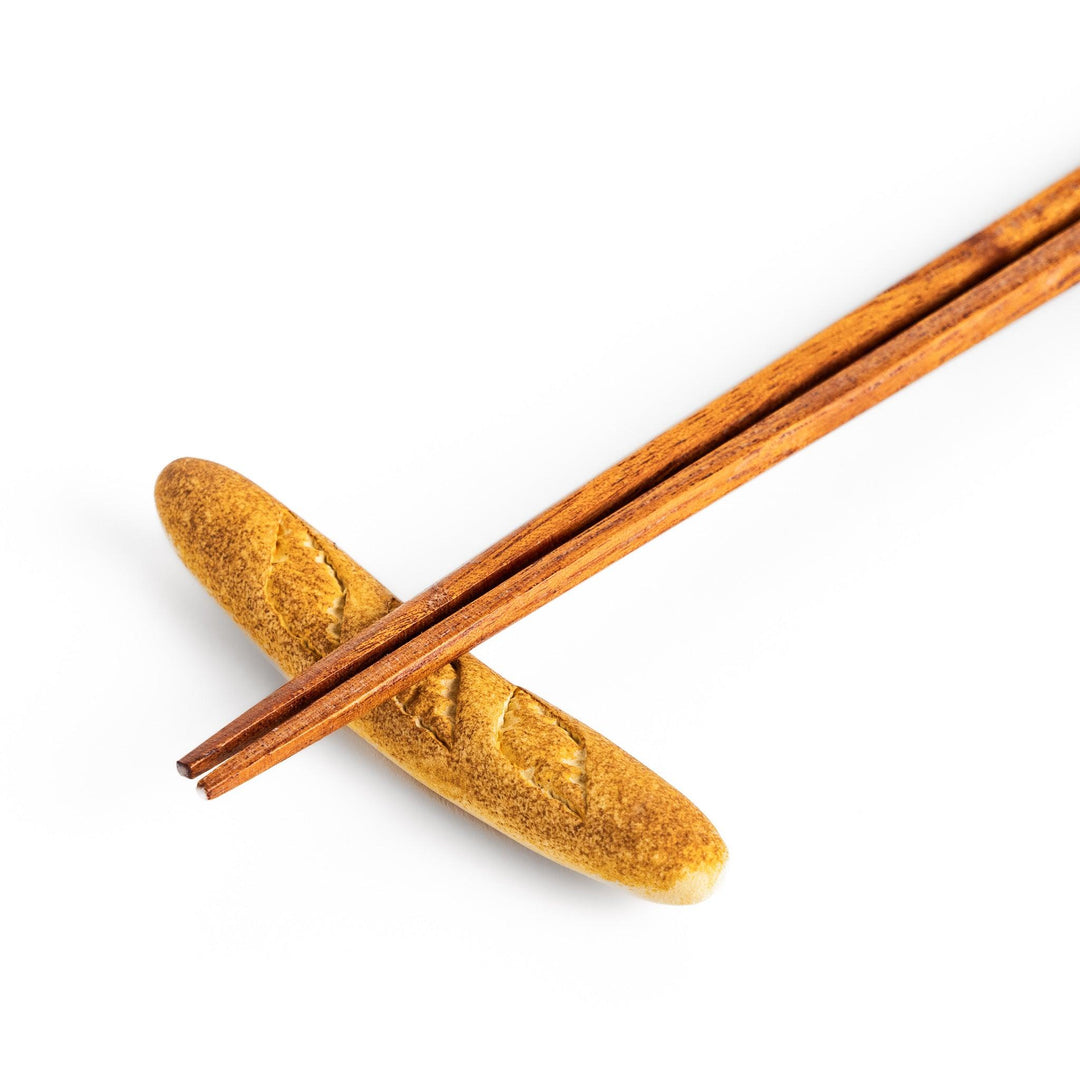 Plain baguette-shaped chopstick rest with a simple, elegant design, featuring detailed imprints resembling the crust of a baguette.