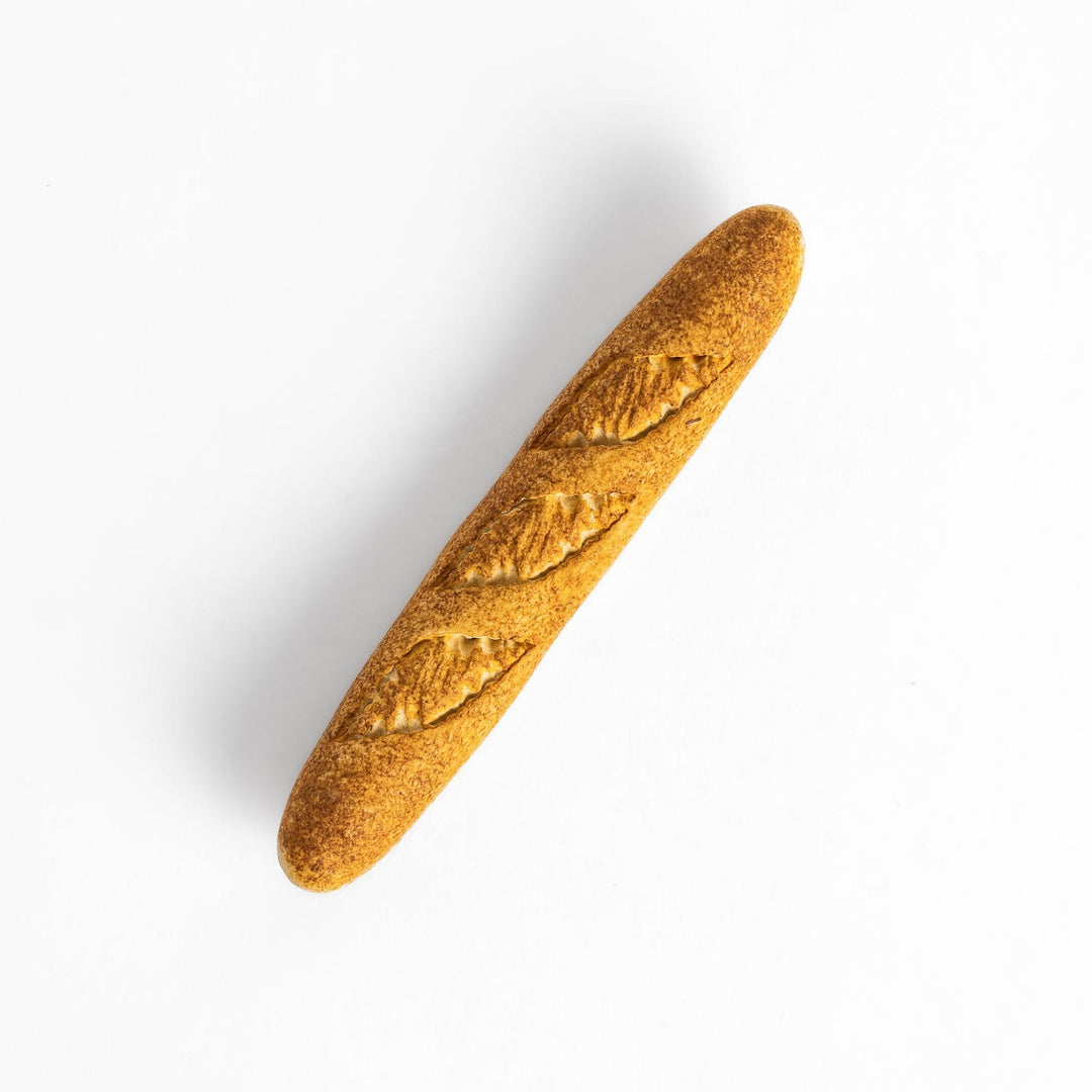 Plain baguette-shaped chopstick rest with a simple, elegant design, featuring detailed imprints resembling the crust of a baguette.